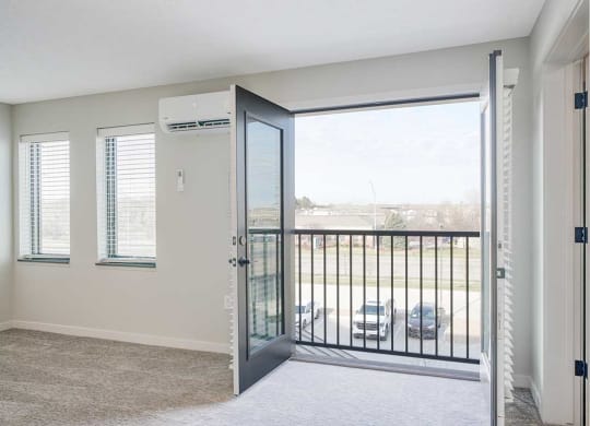 A living room with double doors to a Juliet balcony