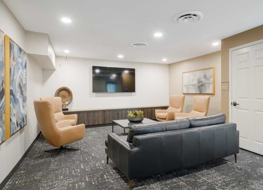 The theater room with private seating a tv