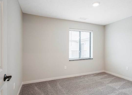 The second bedroom in the Dove floorplan featuring a window