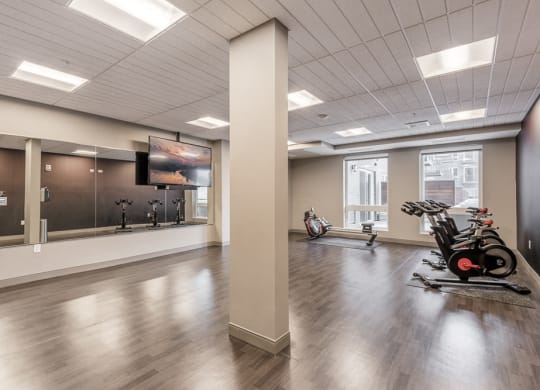 Spin and yoga studio with TV screen for on-demand fitness classes