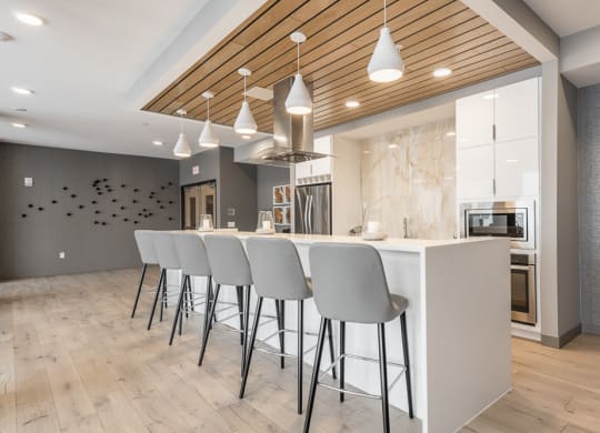 View of gourmet kitchen and bar stools in amenity space at The Preserve in Bloomington