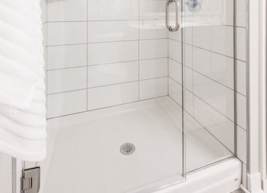Interiors- Bathroom with white cabinets and white, cultured-marble countertops at The Preserve at Normandale Lake