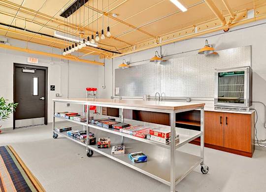 A room with a metal cart and a cabinet.