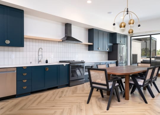 Community space with kitchen and table with seating at The Rowan