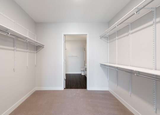 Large walk in closet with ample shelving and hanging space
