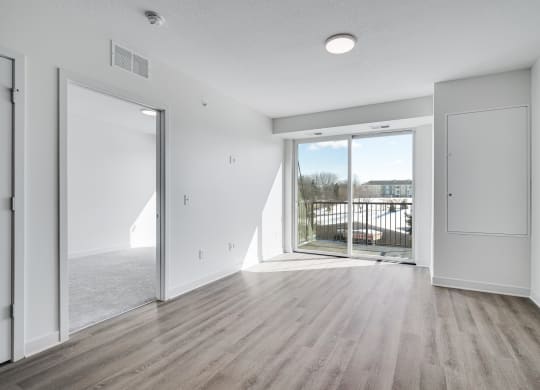 Spacious and bright dining and living area with balcony entry at The Rowan in Eagan Minnesota