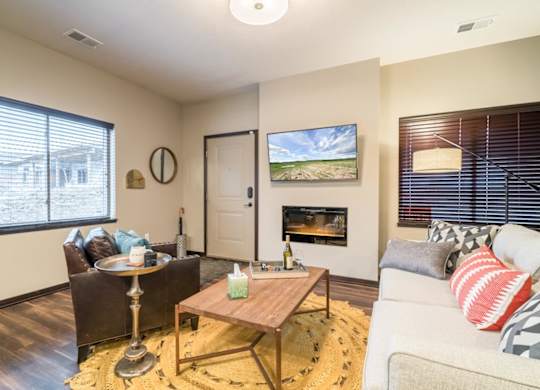 A living room with a fireplace and a painting on the wall.