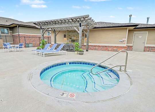 A round above ground pool with a metal railing around it.