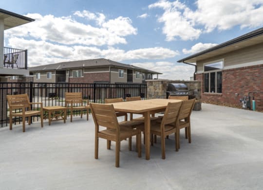 Outdoor tables and grills near the pool at The Villas at Falling Waters townhomes in west Omaha