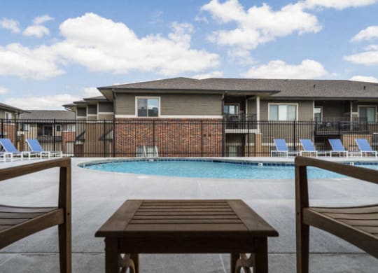Resort-style pool with lounge seating at The Villas at Falling Waters townhomes for rent in West Omaha NE