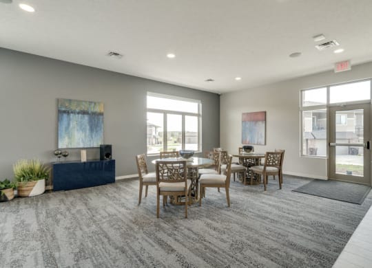 Resident social spaces with chairs and tables at The Villas at Falling Waters townhomes for rent in west Omaha