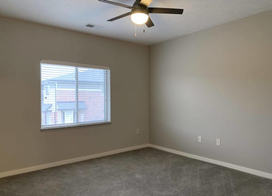 Spacious carpeted bedroom with large window allowing a lot of natural light in at The Villas at Mahoney Park