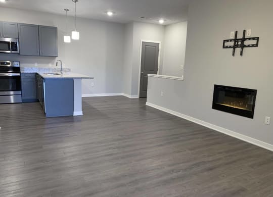 spacious living and dining room with fireplace for extra warmth at the villas at mahoney park
