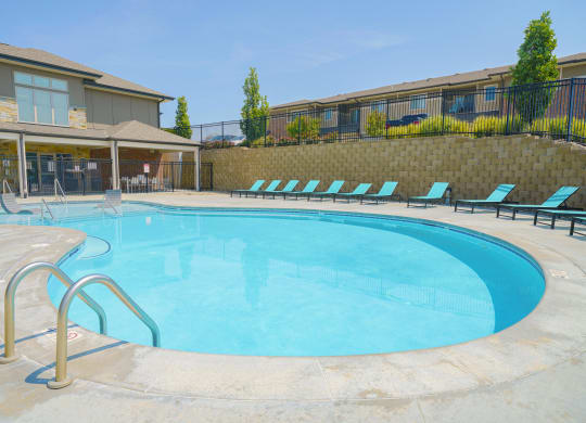 a resort-style pool surrounded by lounge chairs