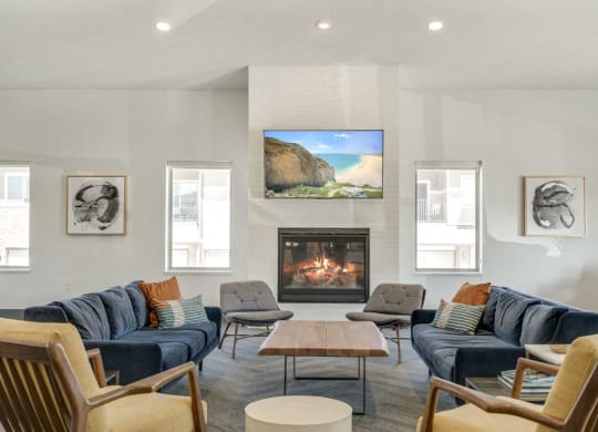 Couches near the fireplace in the clubhouse at The Villas at Mahoney Park