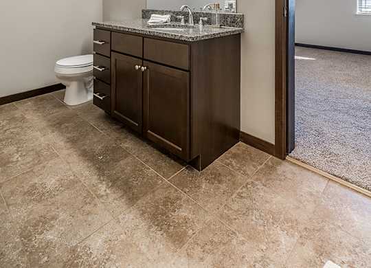 Upscale bathroom with granite countertops and attached walk in closet at the Villas at Wilderness Ridge in Lincoln Nebraska