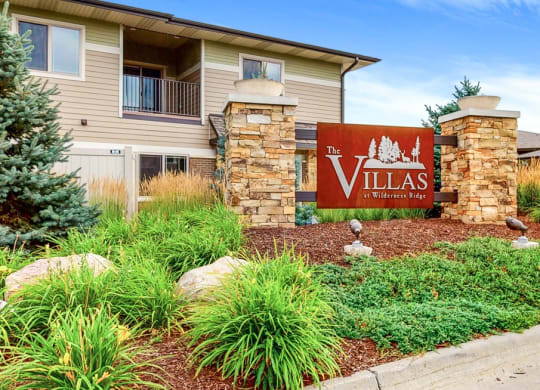 landscaped median with sign reading The Villas at Wilderness Ridge