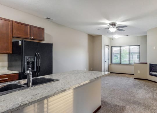 The kitchen in the Ash overlooks the living space with electric fireplace.