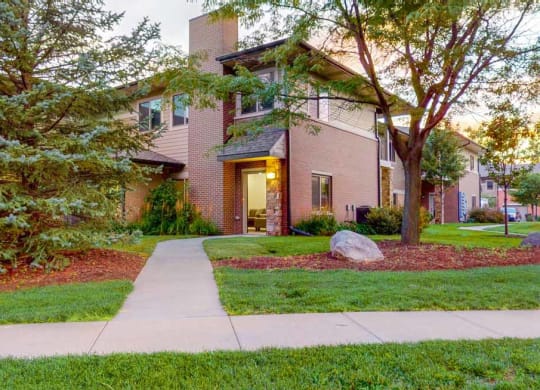an apartment with a sidewalk in front of it
