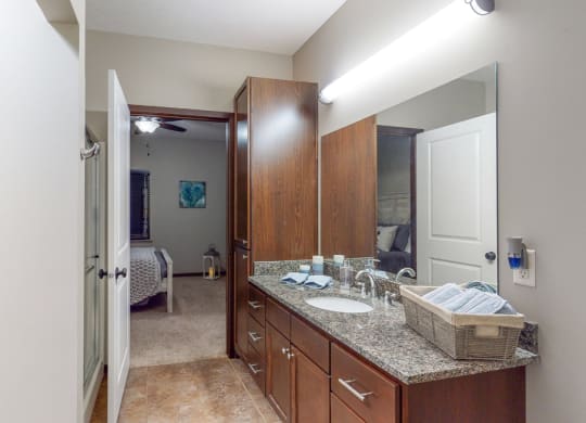 The master bath in the Cedar floor plan features a large vanity, shower, and large linen cabinet.