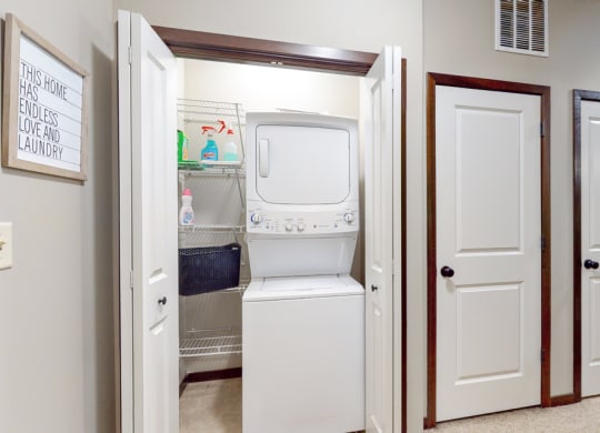 The Cedar features a full-size stacked washer and dryer.