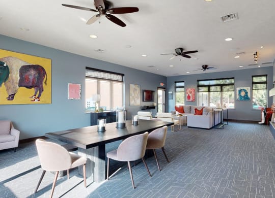 Clubhouse lounge with blue walls and a large yellow painting on the wall