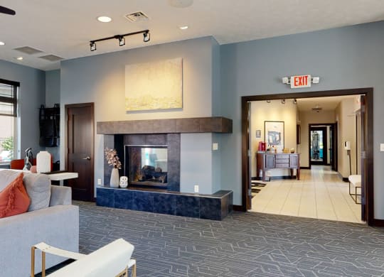 a clubhouse living room with a fireplace and blue walls