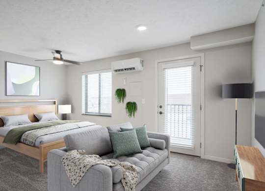 A bedroom with a bed, a couch, and a ceiling fan.