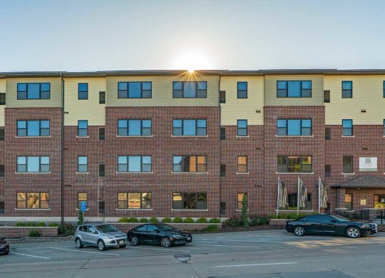 The Helen apartment building exterior with street parking