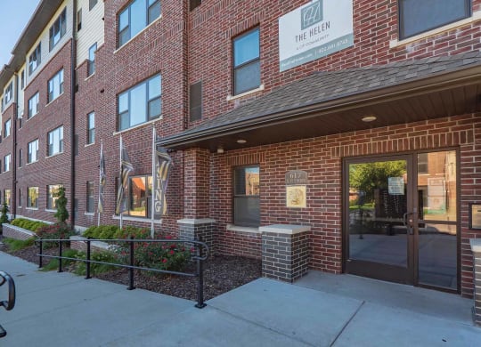 brick building exterior and entrance of The Helen apartments