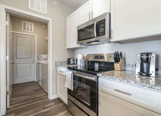 Kitchen including stainless steel smooth top stoves at The Villas at Mahoney Park