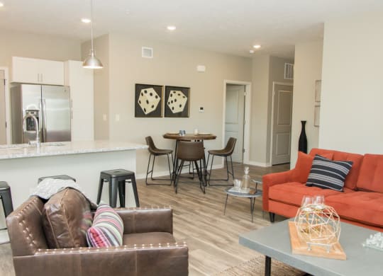 Open layout with living room and kitchen with stainless steel appliances at Villas at Mahoney Park apartments