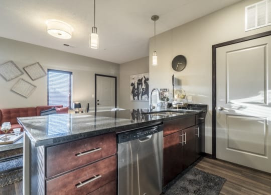 Kitchen with dark cabinets and dark granite counter tops at The Villas at Mahoney Park