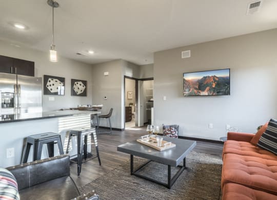 Modern and inviting open layout of living room and kitchen at The Villas at Mahoney Park