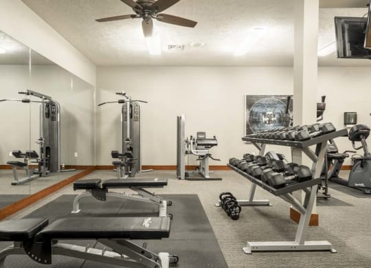 Fitness center with free weights and weightlifting machines at Villas of Omaha townhome apartments in northwest Omaha NE 68116