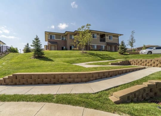 Villa building on top of green hill at Villas of Omaha townhome apartments in northwest Omaha NE 68116
