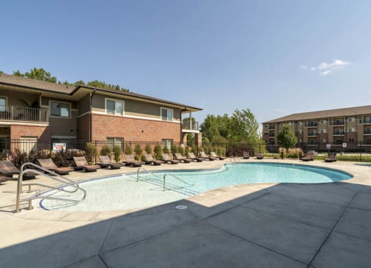 Resort-style pool with lounge chairs at Villas of Omaha in northwest Omaha NE 68116