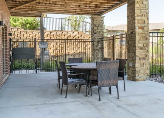 Outdoor seating by pool at Villas of Omaha in northwest Omaha NE 68116