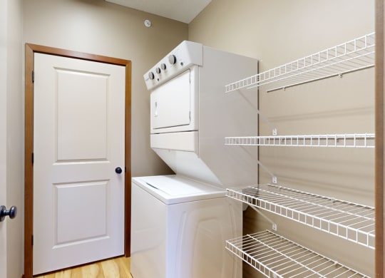 the walk in pantry and laundry space with a door to the mechanical room