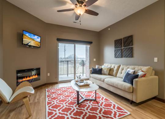 A living room with a fireplace, a couch, and a television.