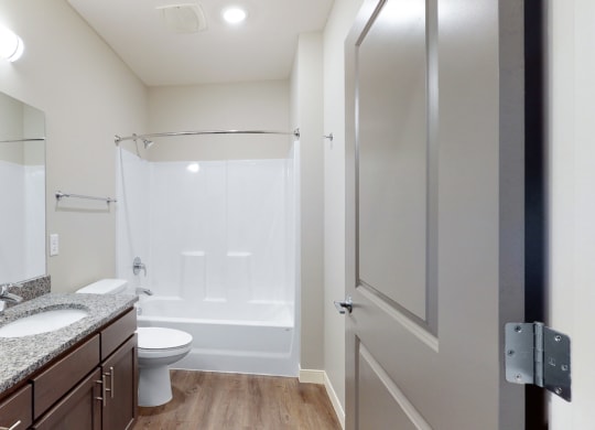 The 2 bedroom Marigold with den floor plan features a spaciou bathroom with granite vanity top and a tub/shower.