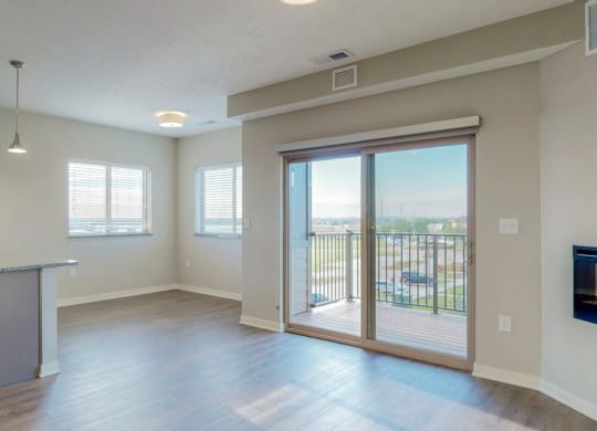 The 2 bedroom Marigold with den floor plan at WH Flats features natural light and a spacious dining and living area with electric fireplace.