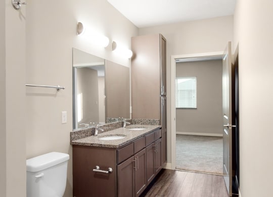 The master bathroom in the Marigold with den floor plan features dual vanity with large shower.