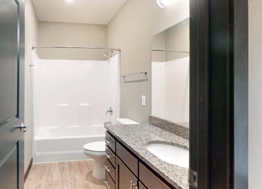 The 2 bedroom Snowdrop with den floor plan features a spacious bathroom with granite vanity top and a tub/shower.