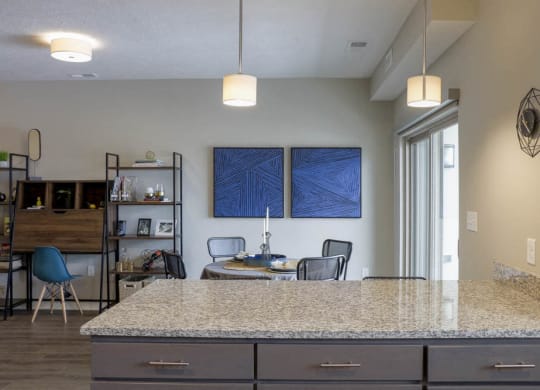 Kitchen peninsula with sophisticated pendant lights at WH Flats new luxury apartments in south Lincoln NE 68516