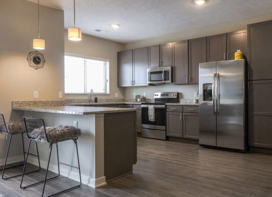 Large kitchen with stainless-steel appliances and peninsula at WH Flats new luxury apartments in south Lincoln NE 68516
