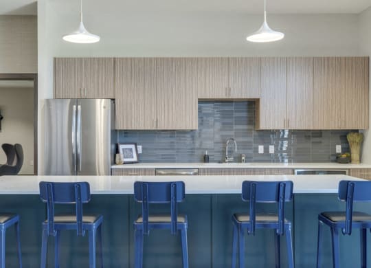 Modern blue chairs at clubhouse kitchen at WH Flats luxury apartments in south Lincoln NE