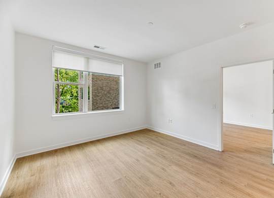 A room with a window and a door.