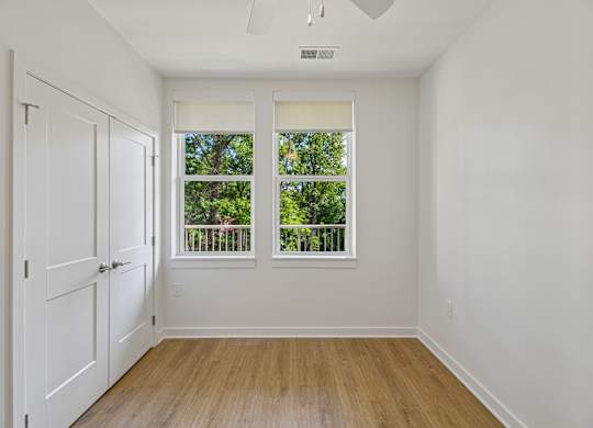 A room with a window and a ceiling fan.