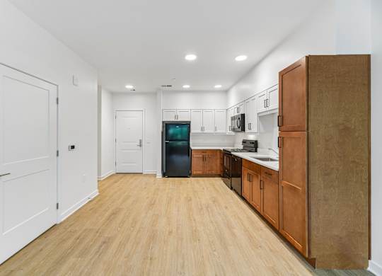 A kitchen with wooden floors and white walls.